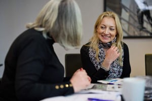 A manager and employee in a professional development review discussing growth opportunities and strengths.