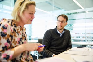 A team leader and colleague talking in a relaxed, respectful environment — showing trust and shared ownership of team energy and workload.