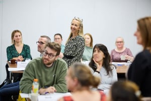 A time-poor team meeting with a manager encouraging reflection and growth through everyday conversations, symbolising development in the flow of work.