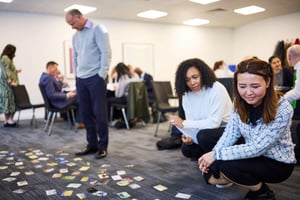 A public sector team in discussion during a strengths-based away day workshop.