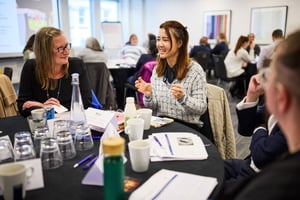 Team members in discussion during a development session, reflecting together on how to improve day-to-day working.