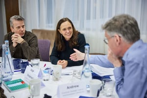 A diverse public sector team engaging in reflective discussion during a team development workshop