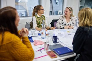 Public sector team in discussion during a facilitated strengths-based workshop session.